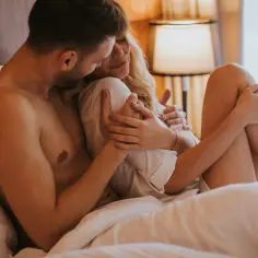 Para w łóżku, czułe objęcia. Może to początek wieczoru z zabawkami erotycznymi dla par?
